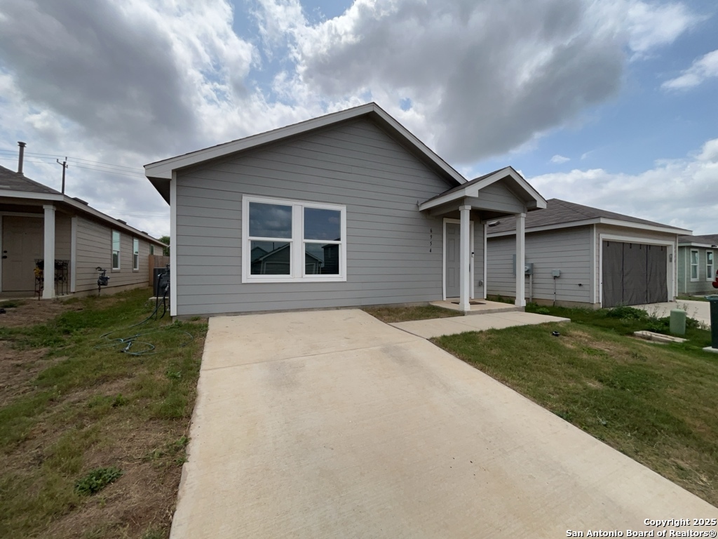 6954 Biotite Ridge Elmendorf, TX 78112 - Photo 30 of 39 a house with trees in the background