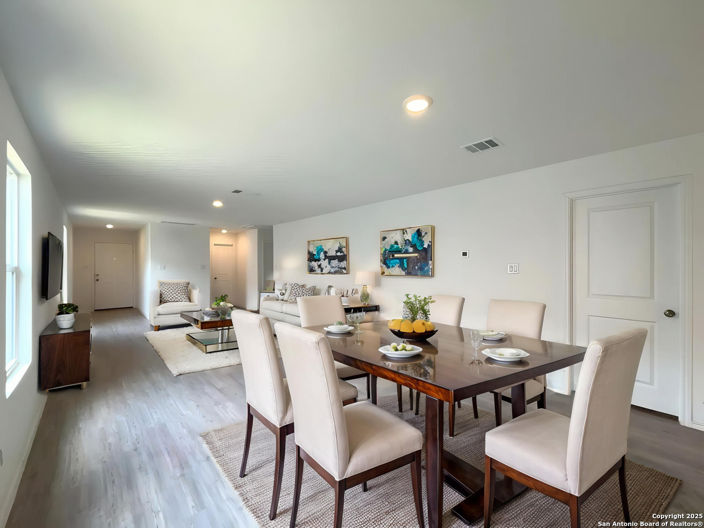 6954 Biotite Ridge Elmendorf, TX 78112 - Photo 3 of 39 a view of a dining room with furniture and wooden floor