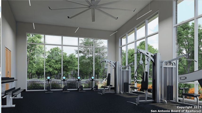 6954 Biotite Ridge Elmendorf, TX 78112 - Photo 38 of 39 a living room with furniture and a floor to ceiling window
