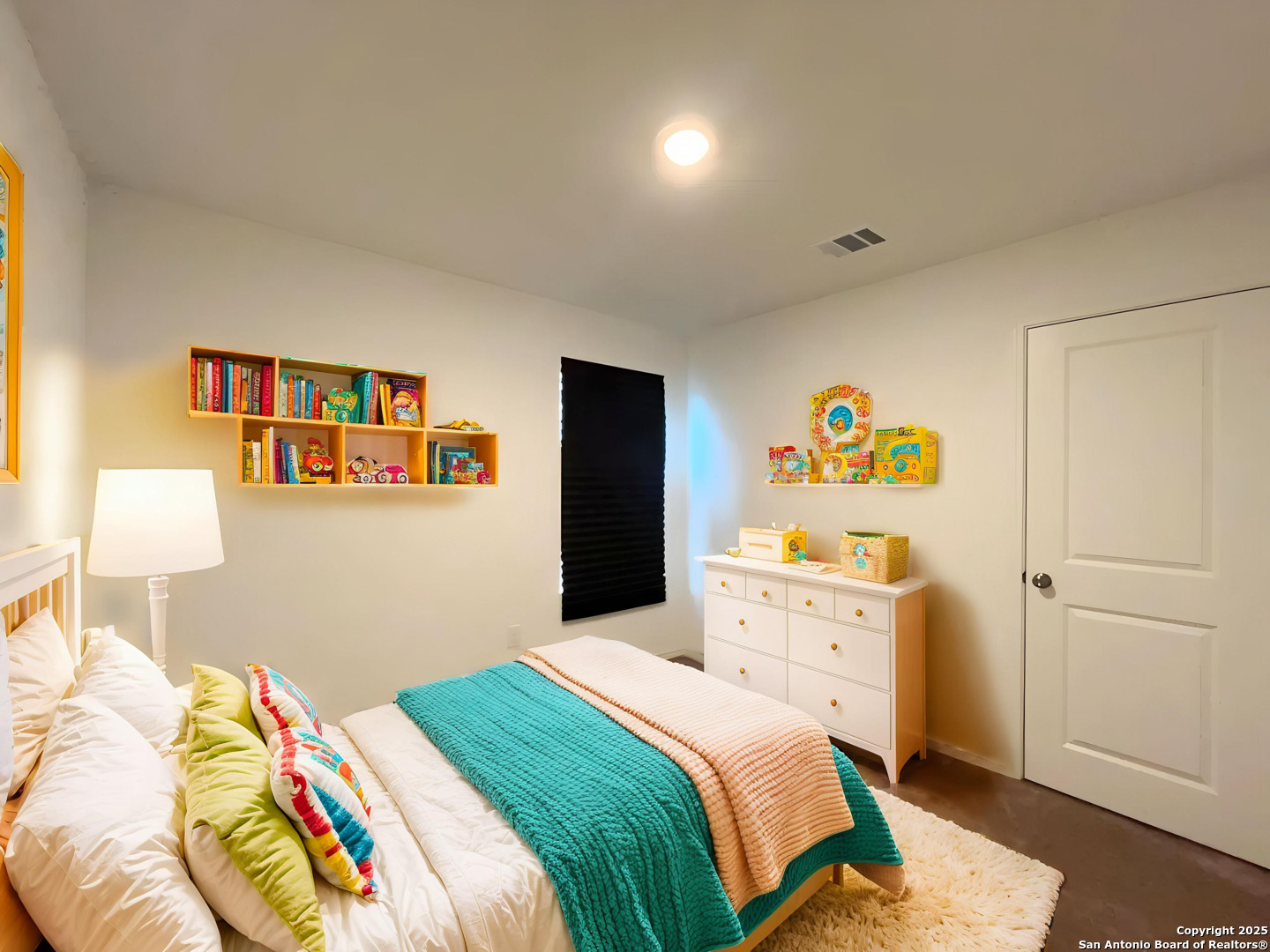 6954 Biotite Ridge Elmendorf, TX 78112 - Photo 6 of 39 a bedroom with a bed and a lamp on dresser