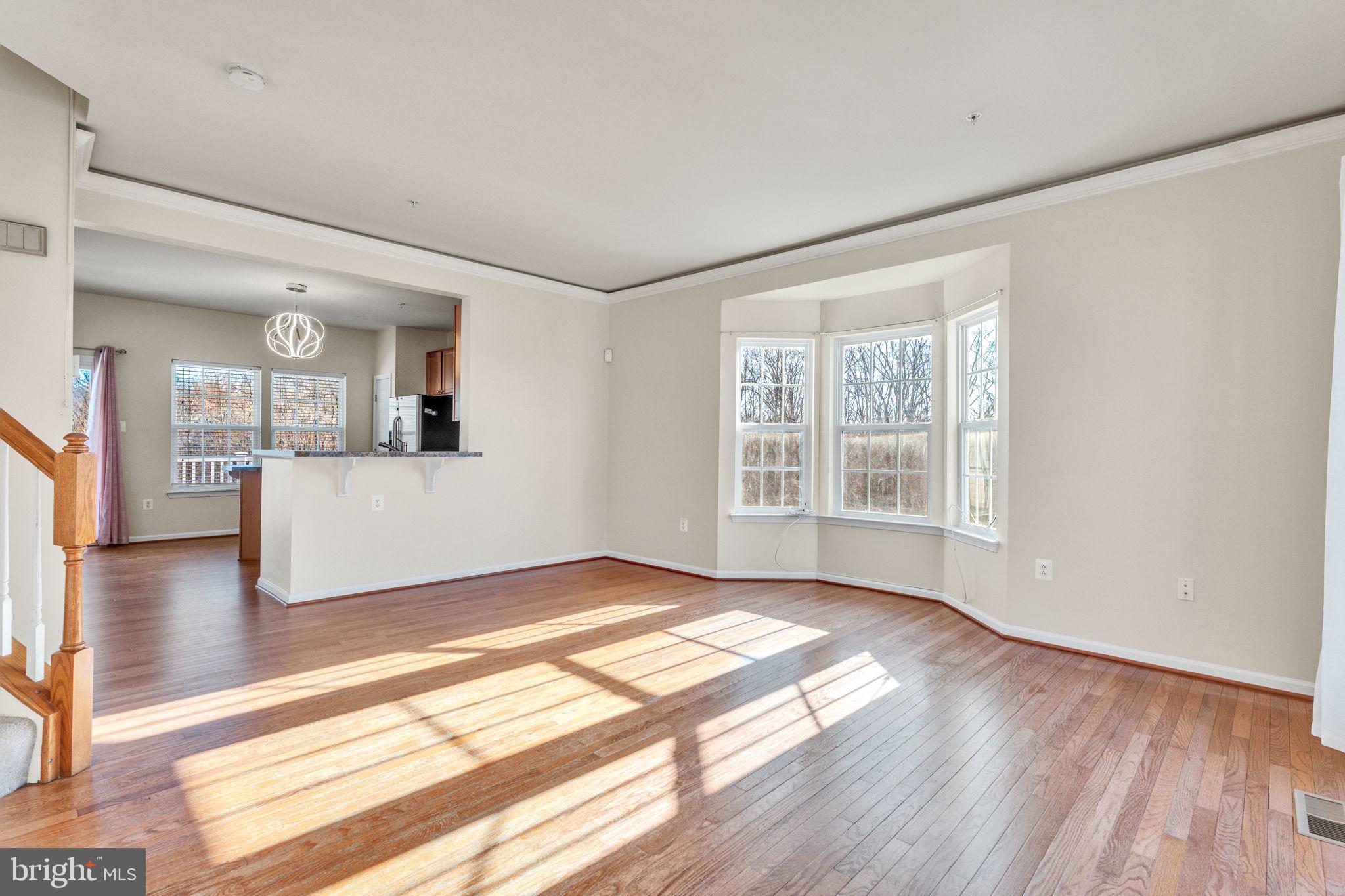 25501 Joy Lane Damascus, MD 20872 - Photo 11 of 35 a view of an empty room with wooden floor and a window