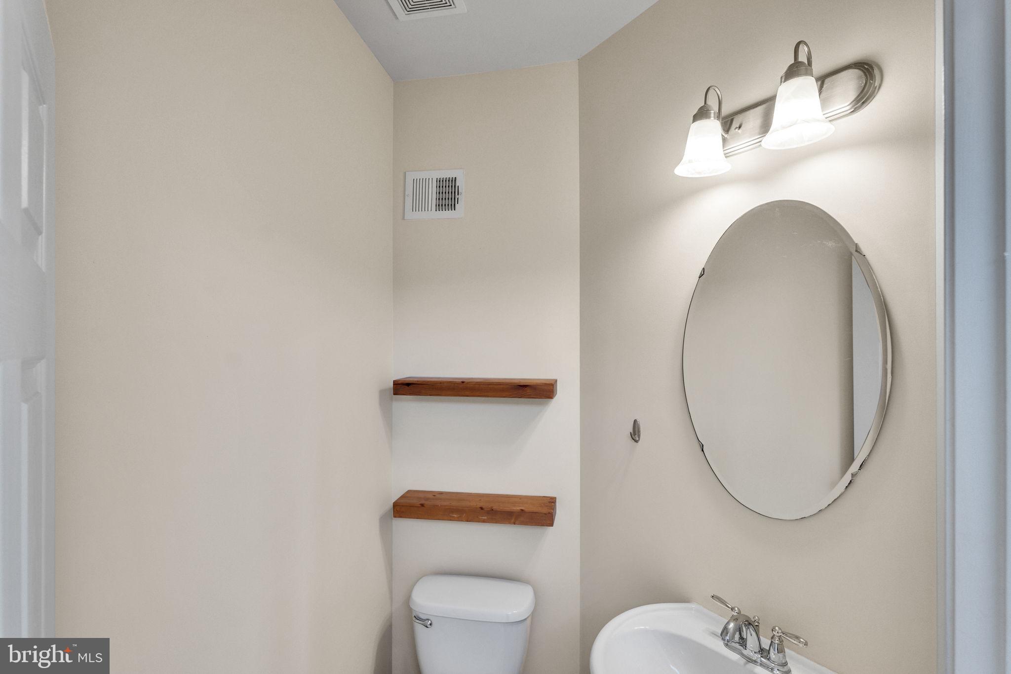 25501 Joy Lane Damascus, MD 20872 - Photo 15 of 35 a bathroom with a toilet and a mirror