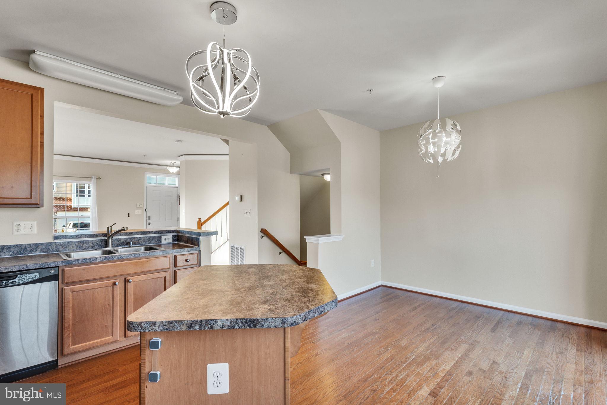 25501 Joy Lane Damascus, MD 20872 - Photo 17 of 35 a kitchen with granite countertop a stove a sink and a chandelier