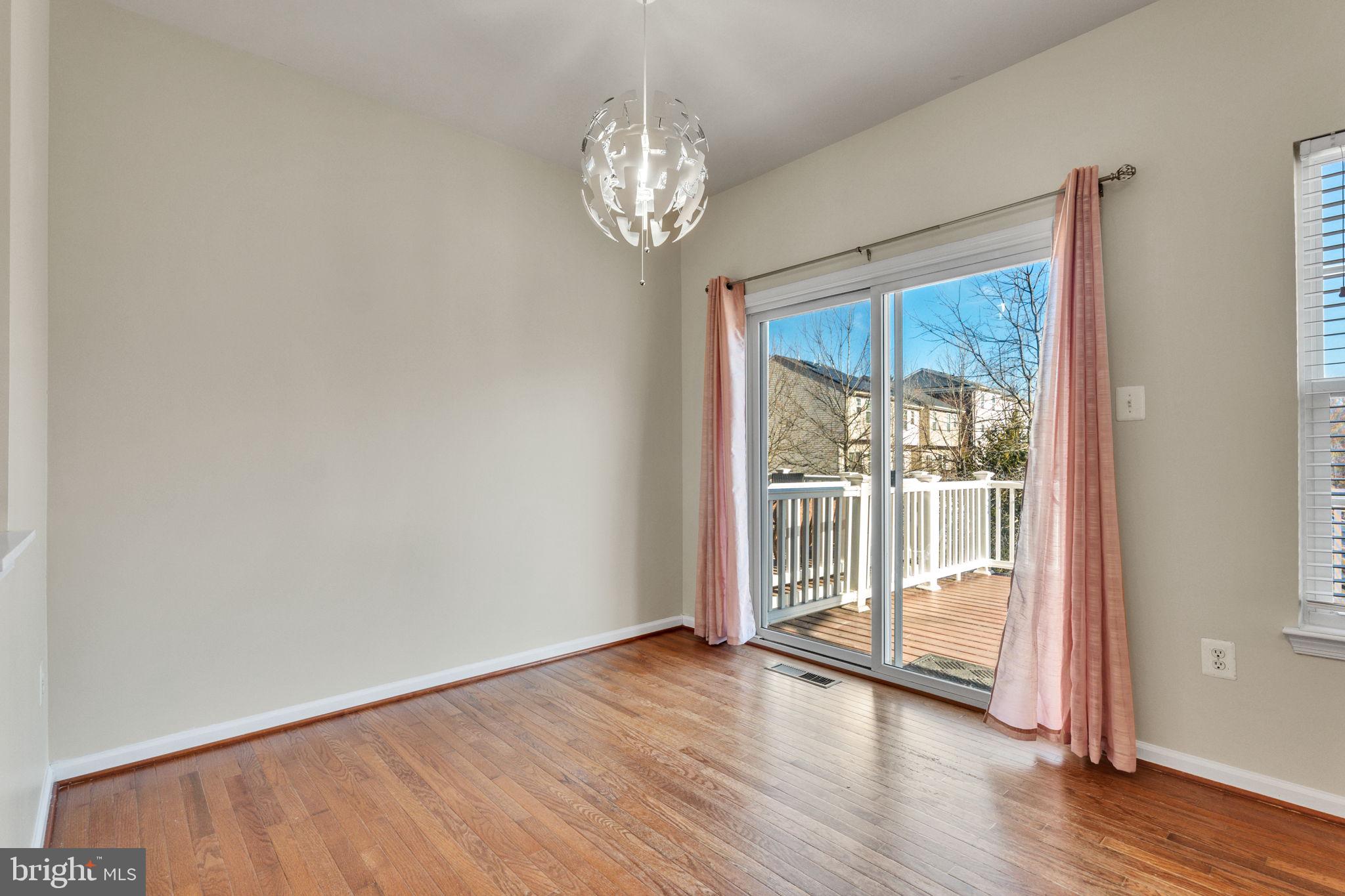 25501 Joy Lane Damascus, MD 20872 - Photo 19 of 35 a view of an empty room with wooden floor and a window