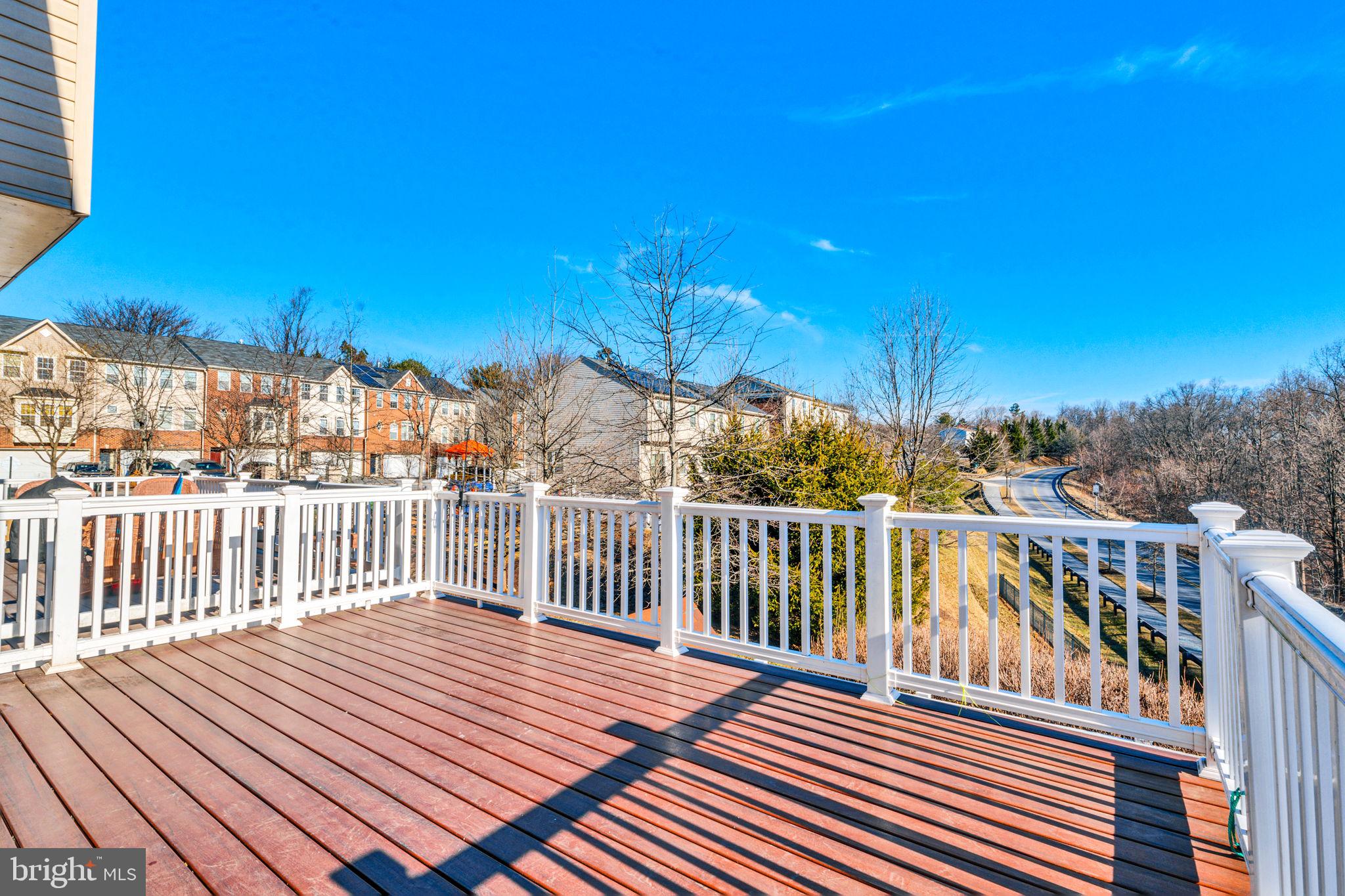 25501 Joy Lane Damascus, MD 20872 - Photo 21 of 35 a view of a rooftop deck with chairs and wooden floor