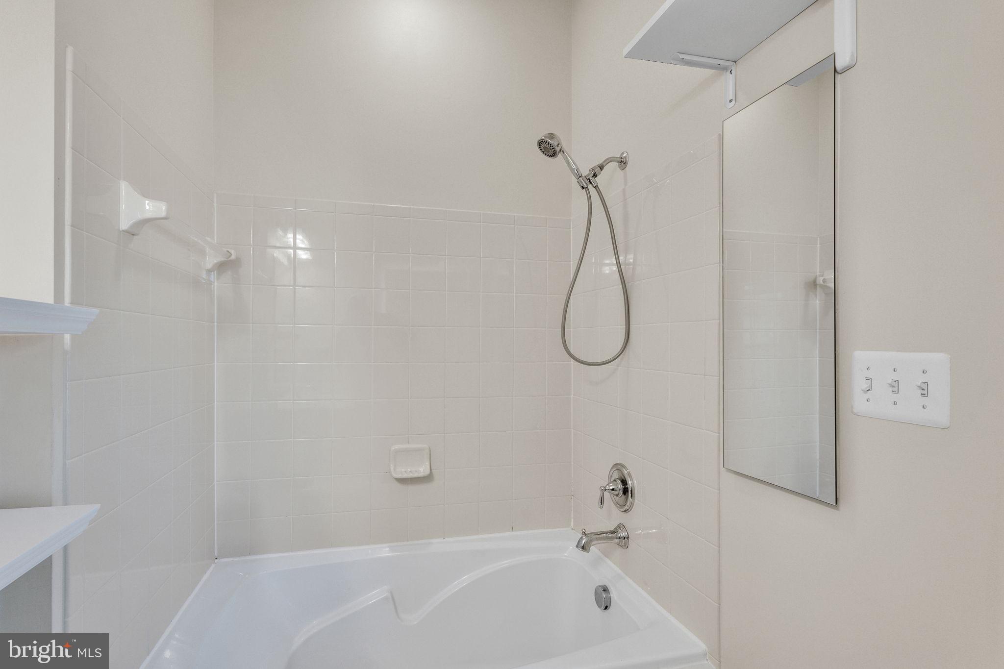 25501 Joy Lane Damascus, MD 20872 - Photo 26 of 35 a bathroom with a bath tub with a shower