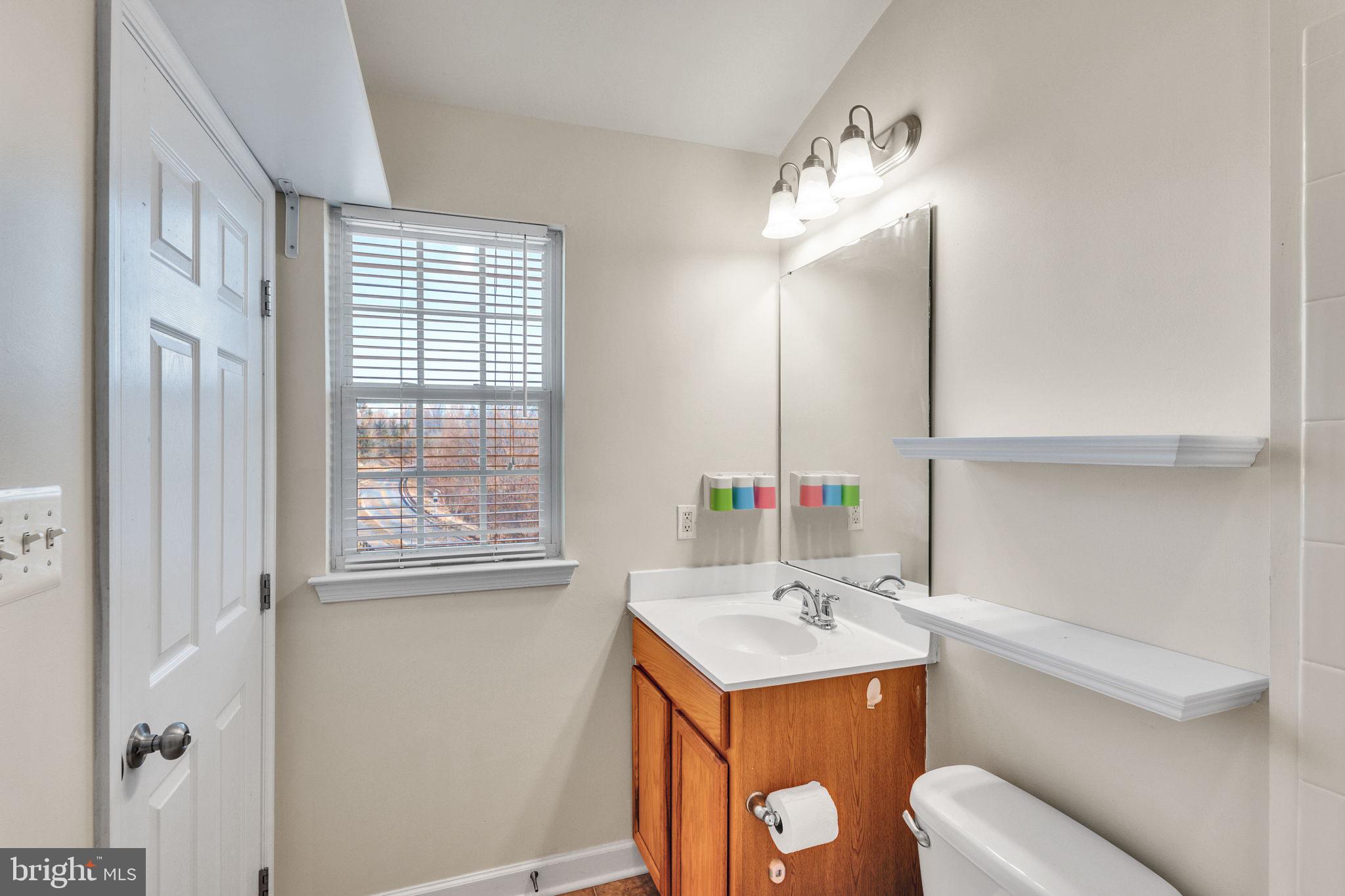 25501 Joy Lane Damascus, MD 20872 - Photo 33 of 35 a bathroom with a sink and a mirror