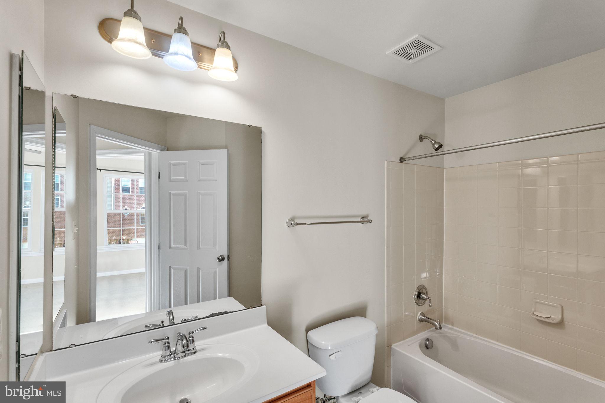 25501 Joy Lane Damascus, MD 20872 - Photo 34 of 35 a bathroom with a tub a sink and mirror