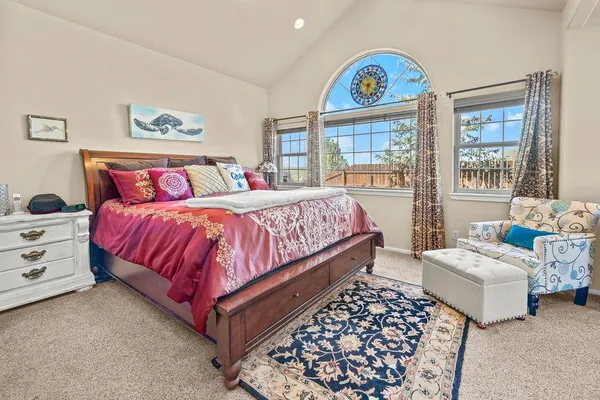 a bedroom with bed and a large window