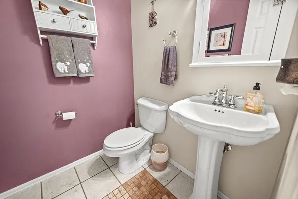 a bathroom with a sink toilet and a mirror