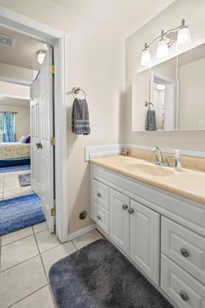 a spacious bathroom with a sink and a mirror