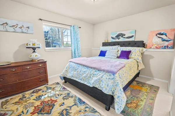 a bedroom with a bed and window