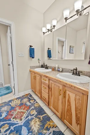 a spacious bathroom with a sink a vanity and a mirror