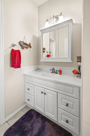 a bathroom with a sink vanity and mirror