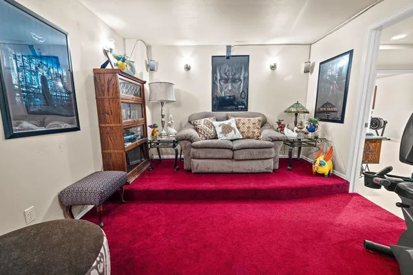 a bedroom with a bed and a painting on the wall