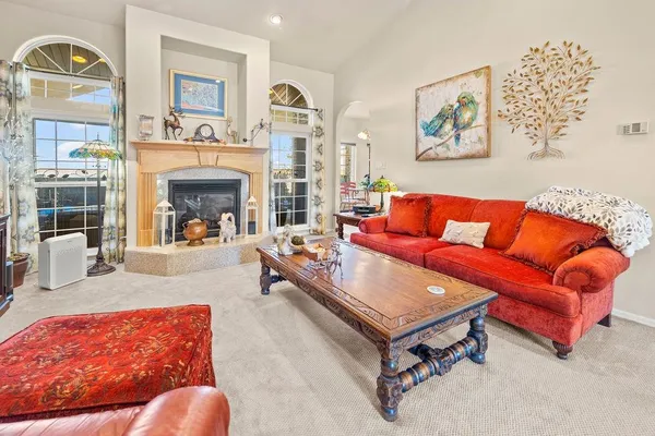 a living room with furniture and a fireplace