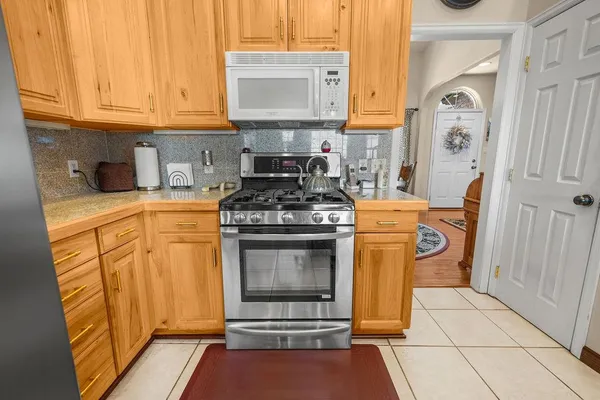 a kitchen with stainless steel appliances granite countertop a stove and a refrigerator