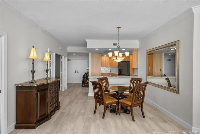 a view of a dining room with furniture and chandelier