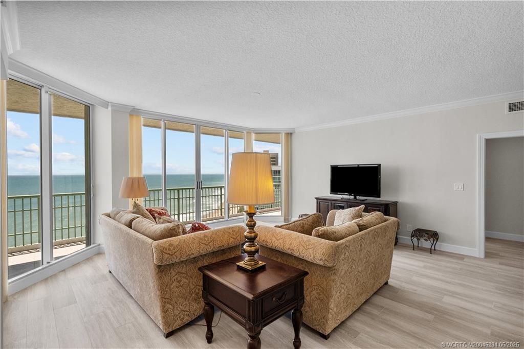 8600 South Ocean Drive, Unit PH5 Jensen Beach, FL 34957 - Photo 16 of 49 a living room with furniture and a flat screen tv