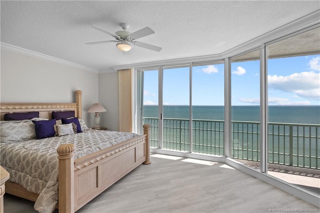 8600 South Ocean Drive, Unit PH5 Jensen Beach, FL 34957 - Photo 21 of 49 a bedroom with a large bed and a large window