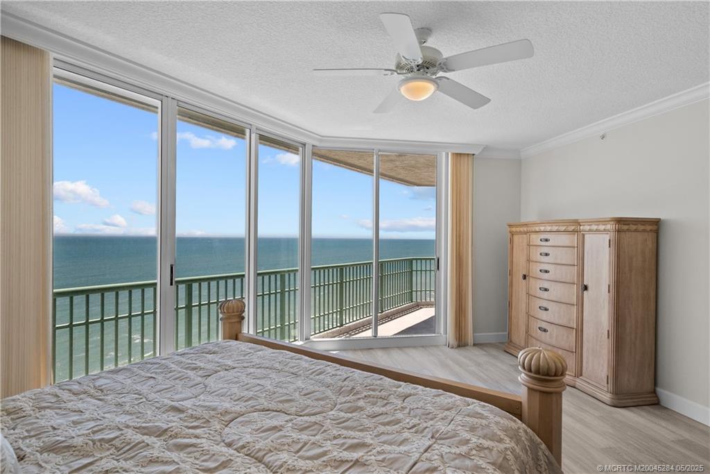 8600 South Ocean Drive, Unit PH5 Jensen Beach, FL 34957 - Photo 22 of 49 a bedroom with a bed and a large window