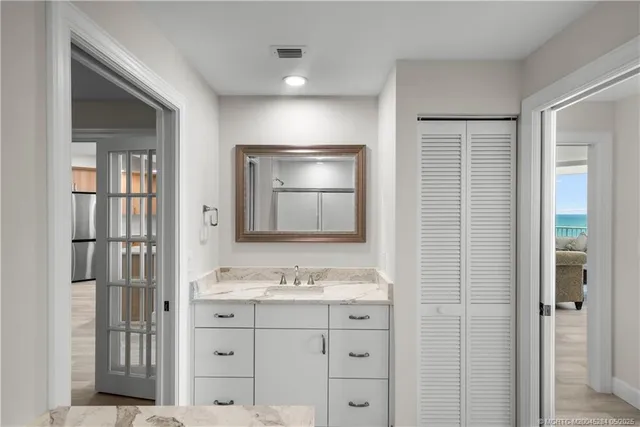 a bathroom with a shower sink and mirror