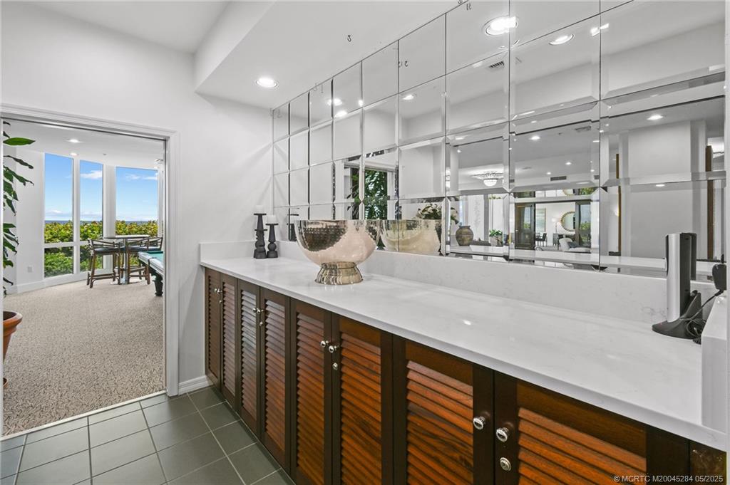 8600 South Ocean Drive, Unit PH5 Jensen Beach, FL 34957 - Photo 43 of 49 a bathroom with a sink a double vanity and a mirror
