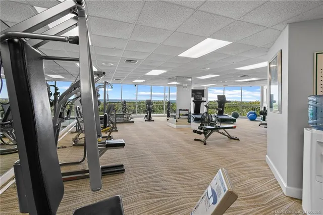 a view of a gym with lots of furniture and a large window