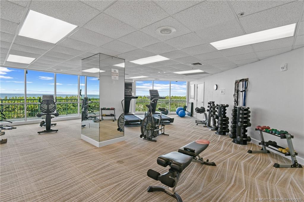 8600 South Ocean Drive, Unit PH5 Jensen Beach, FL 34957 - Photo 47 of 49 a view of a gym with lots of furniture and a large window