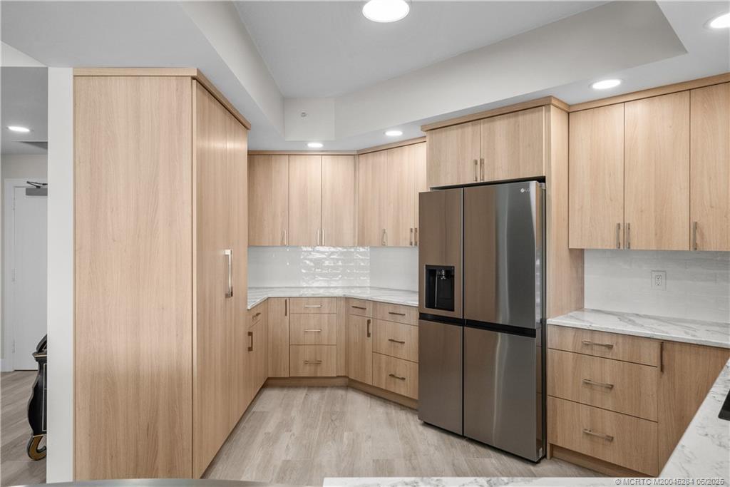 8600 South Ocean Drive, Unit PH5 Jensen Beach, FL 34957 - Photo 7 of 49 a kitchen with cabinets and stainless steel appliances