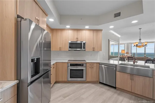 a kitchen with stainless steel appliances granite countertop a refrigerator and a sink