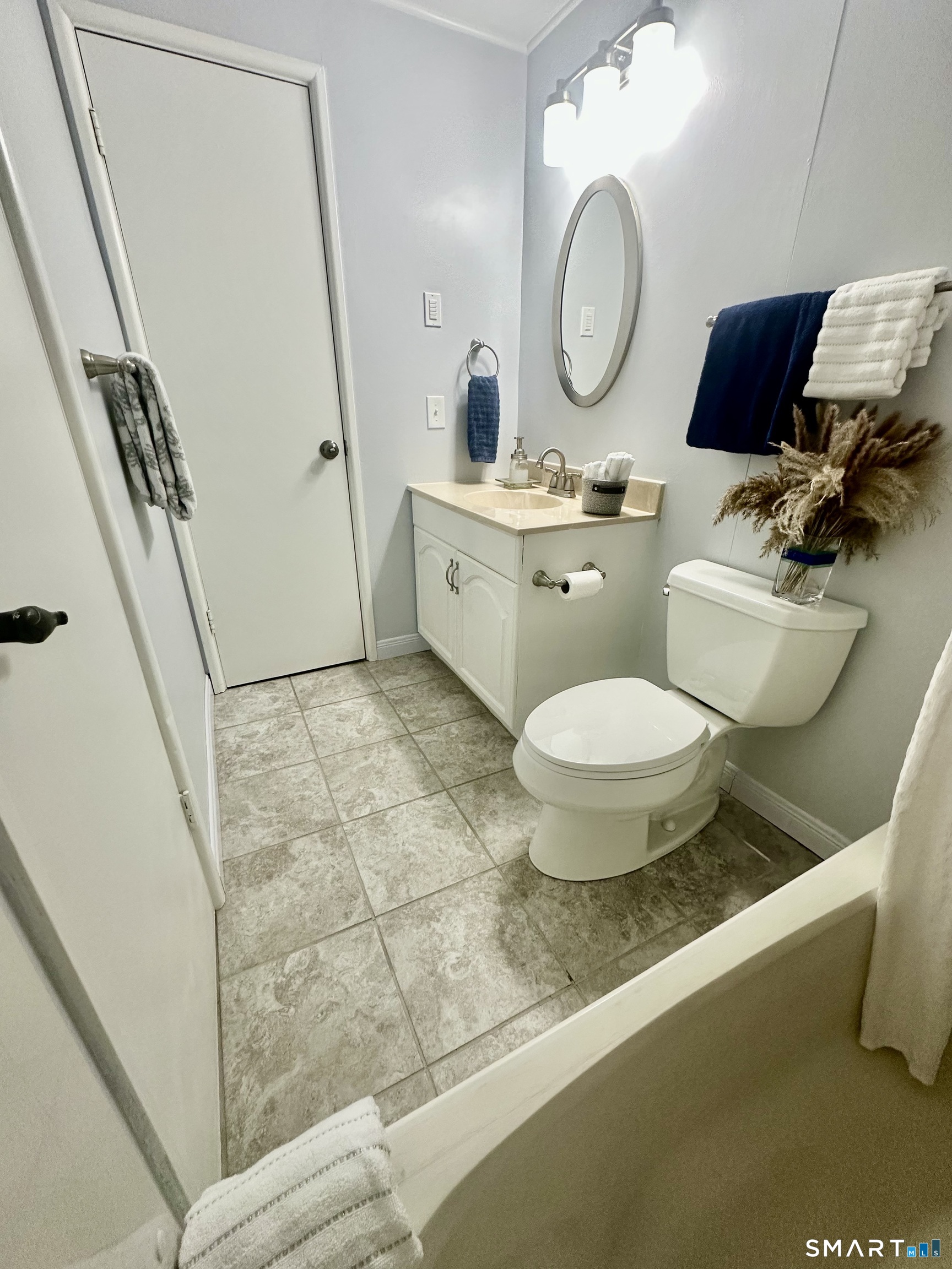 2 Lakeside Drive, Unit M Ledyard, CT 06339 - Photo 26 of 38 a bathroom with a toilet sink and mirror