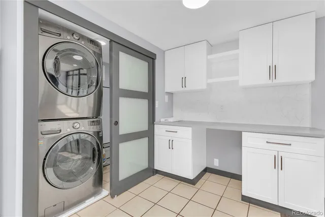 a utility room with sink dryer and washer