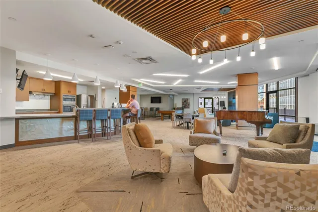 a living room with furniture and view of kitchen
