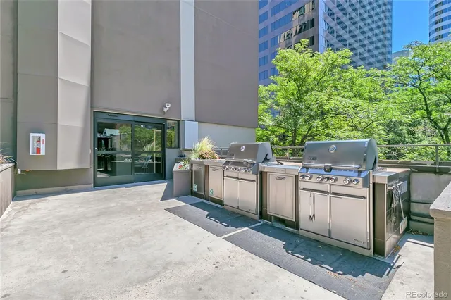 a view of a balcony with outdoor seating and plants