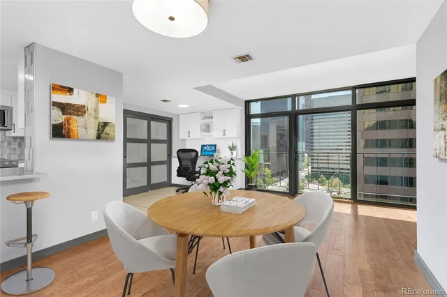 a view of a dining room with furniture and wooden floor