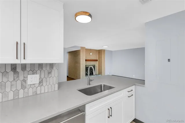a kitchen with a sink a stove and cabinets
