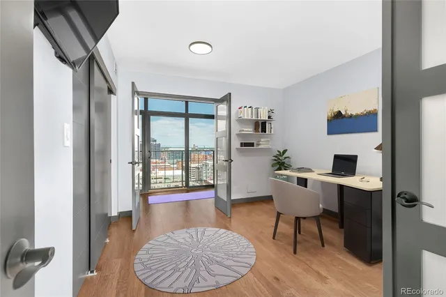 a living room with furniture a dining table and a large window