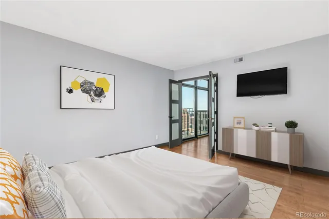 a bedroom with a bed and a flat screen tv