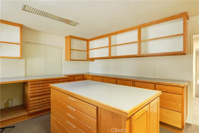 a kitchen that has a sink and a chair