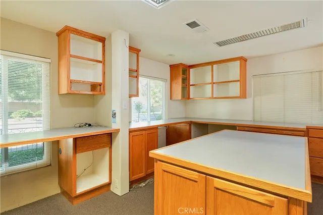 a room with pool table and windows