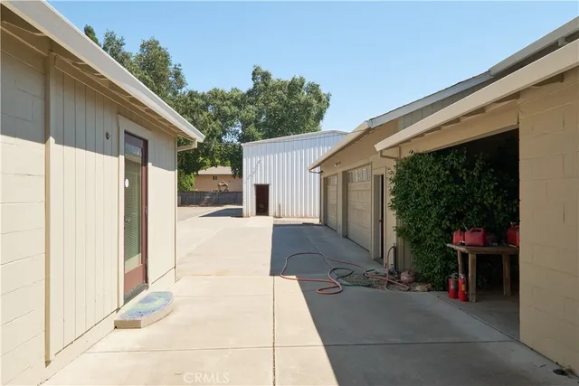 a view of a patio with table and chairs and floor to ceiling window