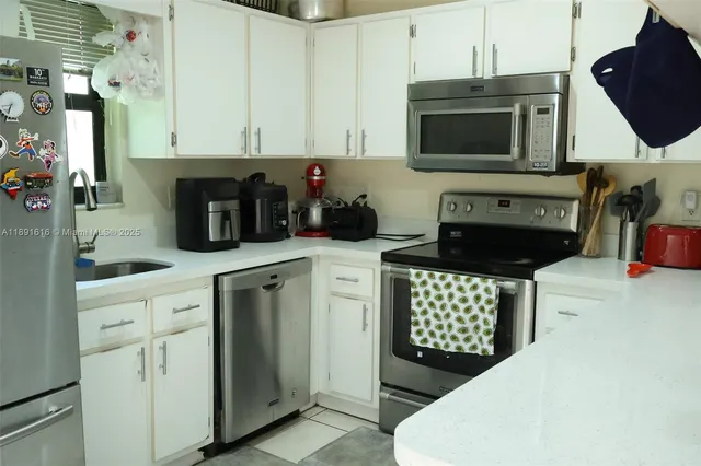 a kitchen with stainless steel appliances a stove microwave and cabinets