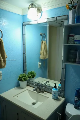 a bathroom with a sink and a mirror