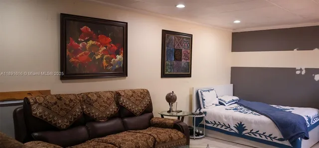a bedroom with a bed couch and painting on the wall