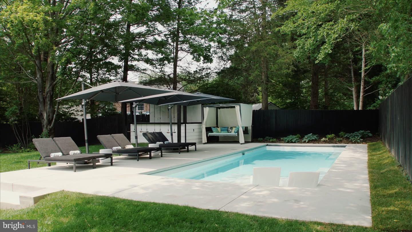 8100 Lewinsville Road McLean, VA 22102 - Photo 2 of 49 a view of a swimming pool with sitting area and furniture