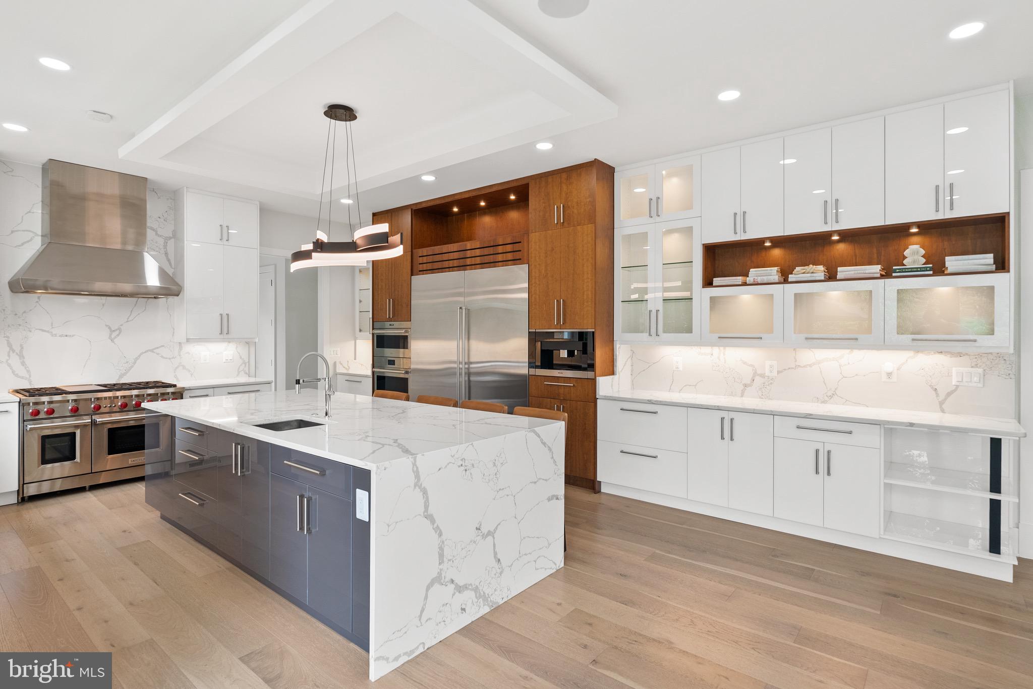 8100 Lewinsville Road McLean, VA 22102 - Photo 26 of 49 a kitchen with stainless steel appliances granite countertop a stove top oven a refrigerator a sink and dishwasher with white cabinets