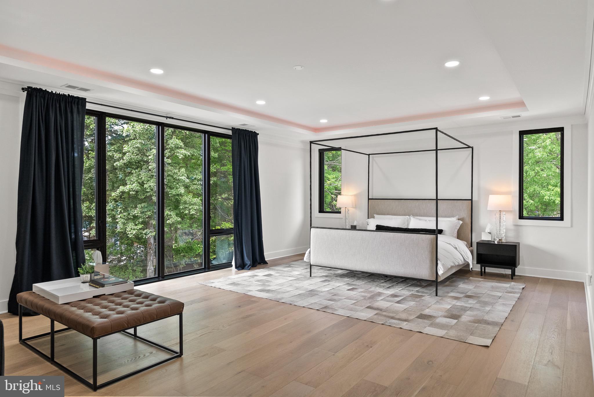 8100 Lewinsville Road McLean, VA 22102 - Photo 30 of 49 a spacious bedroom with a large bed and a large window