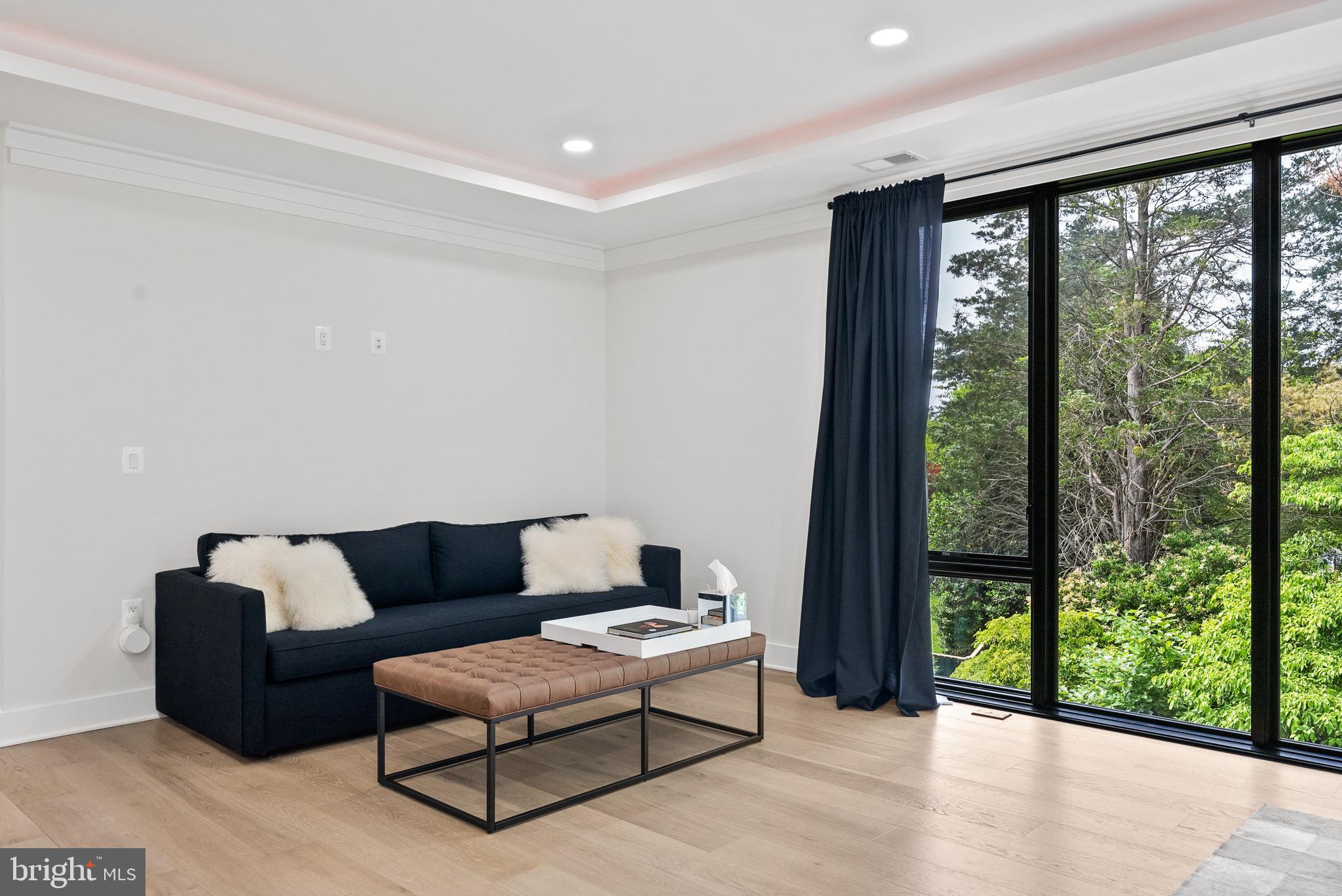 8100 Lewinsville Road McLean, VA 22102 - Photo 31 of 49 a living room with furniture and a floor to ceiling window