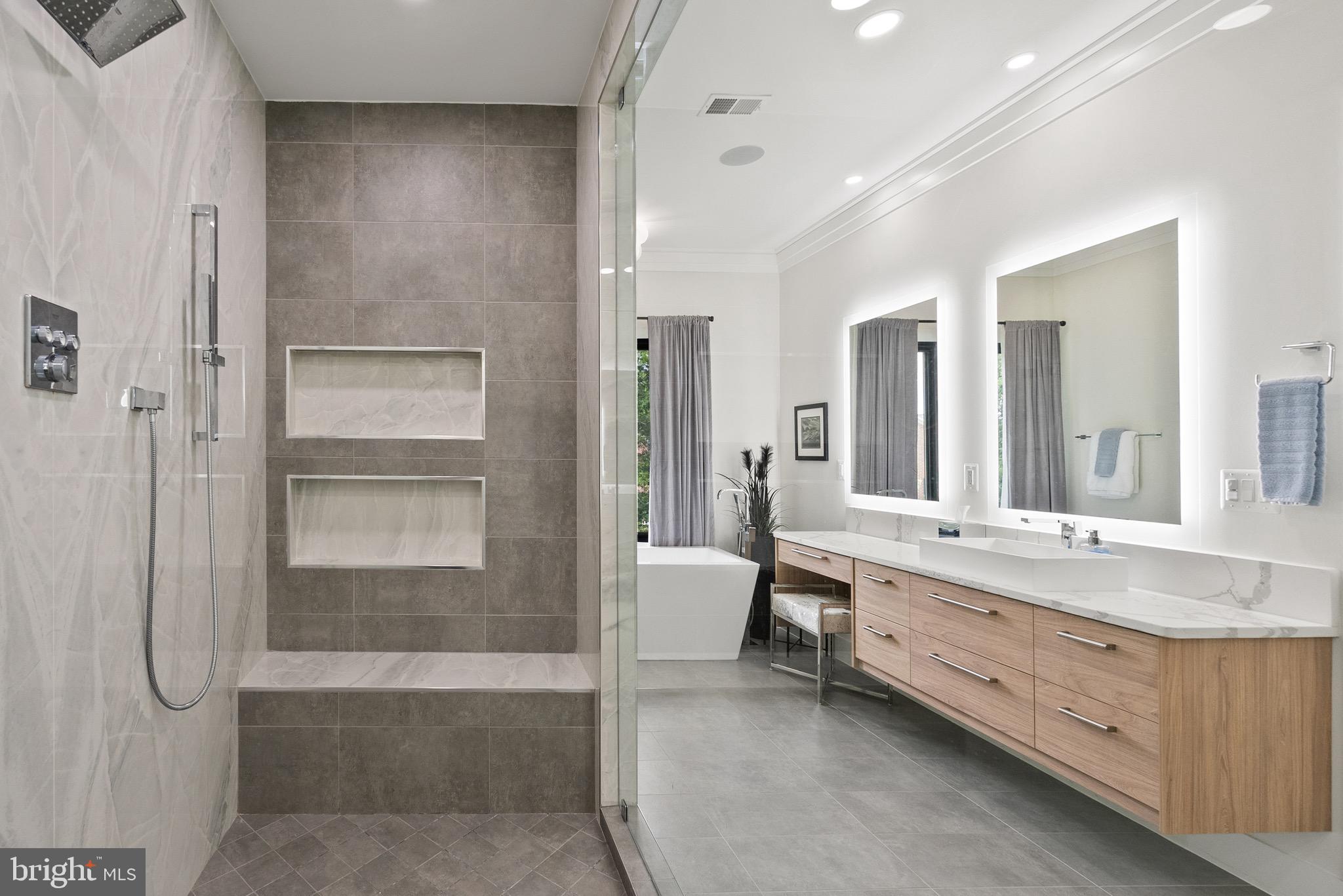 8100 Lewinsville Road McLean, VA 22102 - Photo 35 of 49 a bathroom with a granite countertop sink mirror and bathtub
